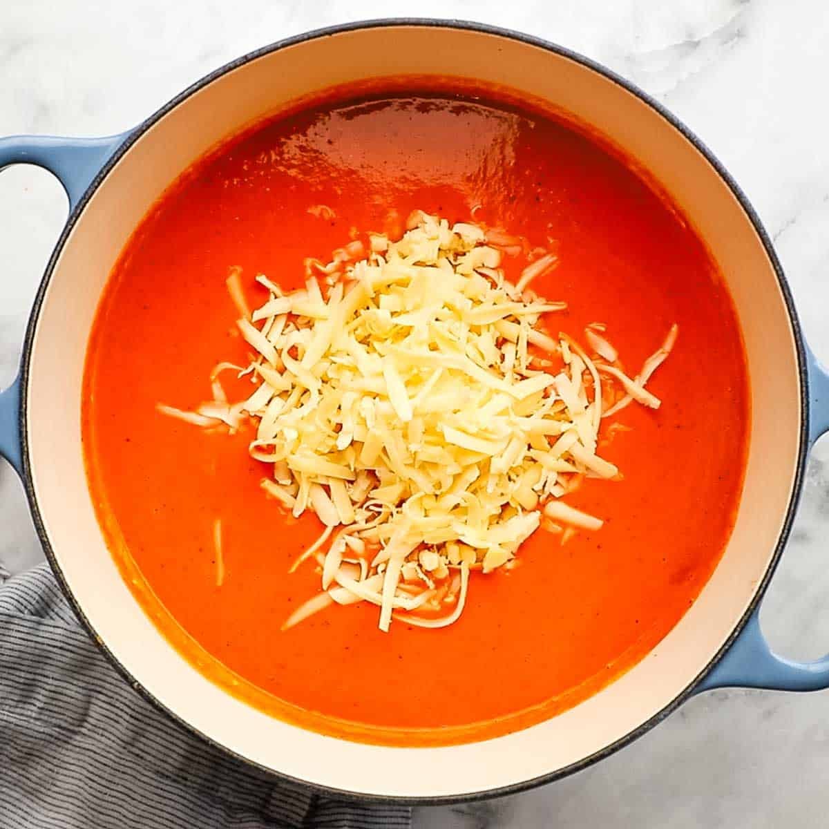 Gouda cheese gently folded into the soup after being removed from the heat.