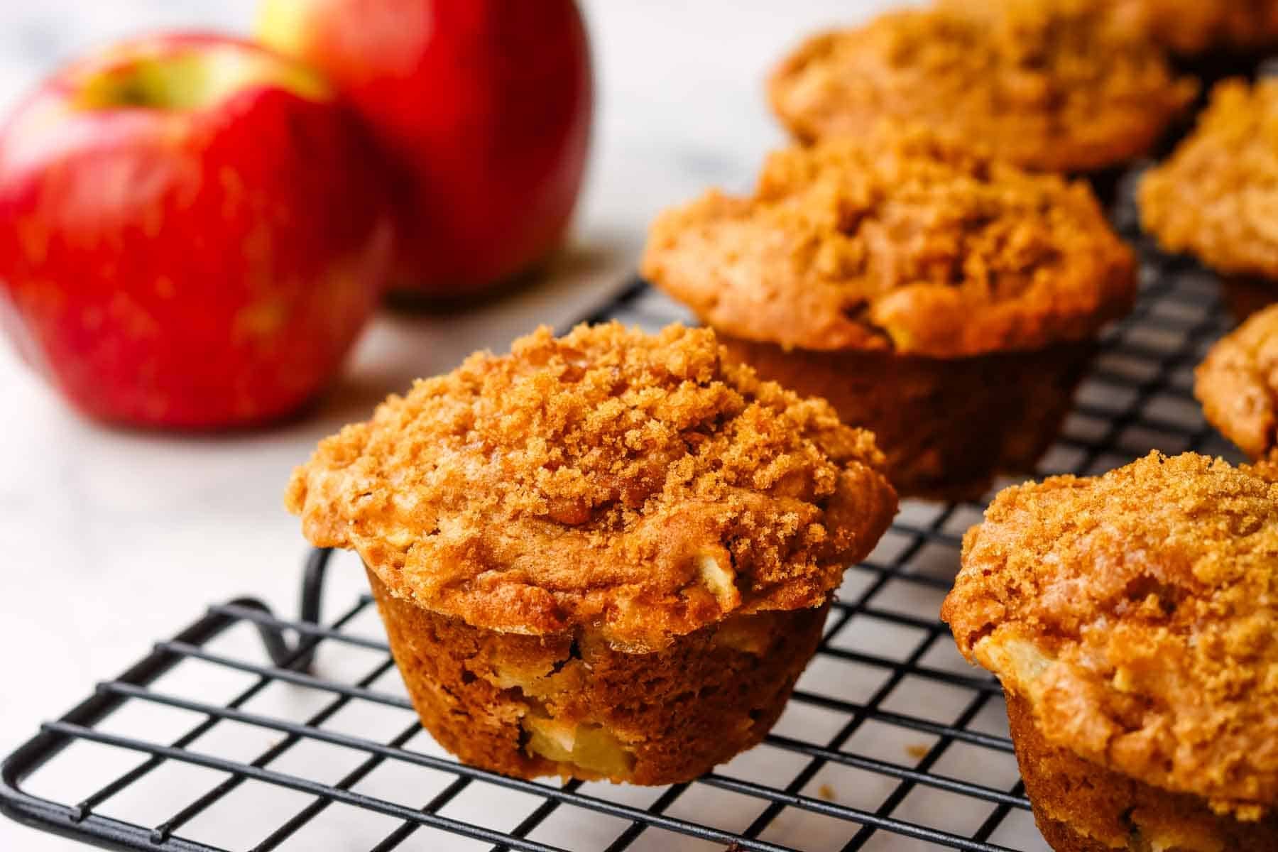 apple sour cream muffins cooling on a wire rack