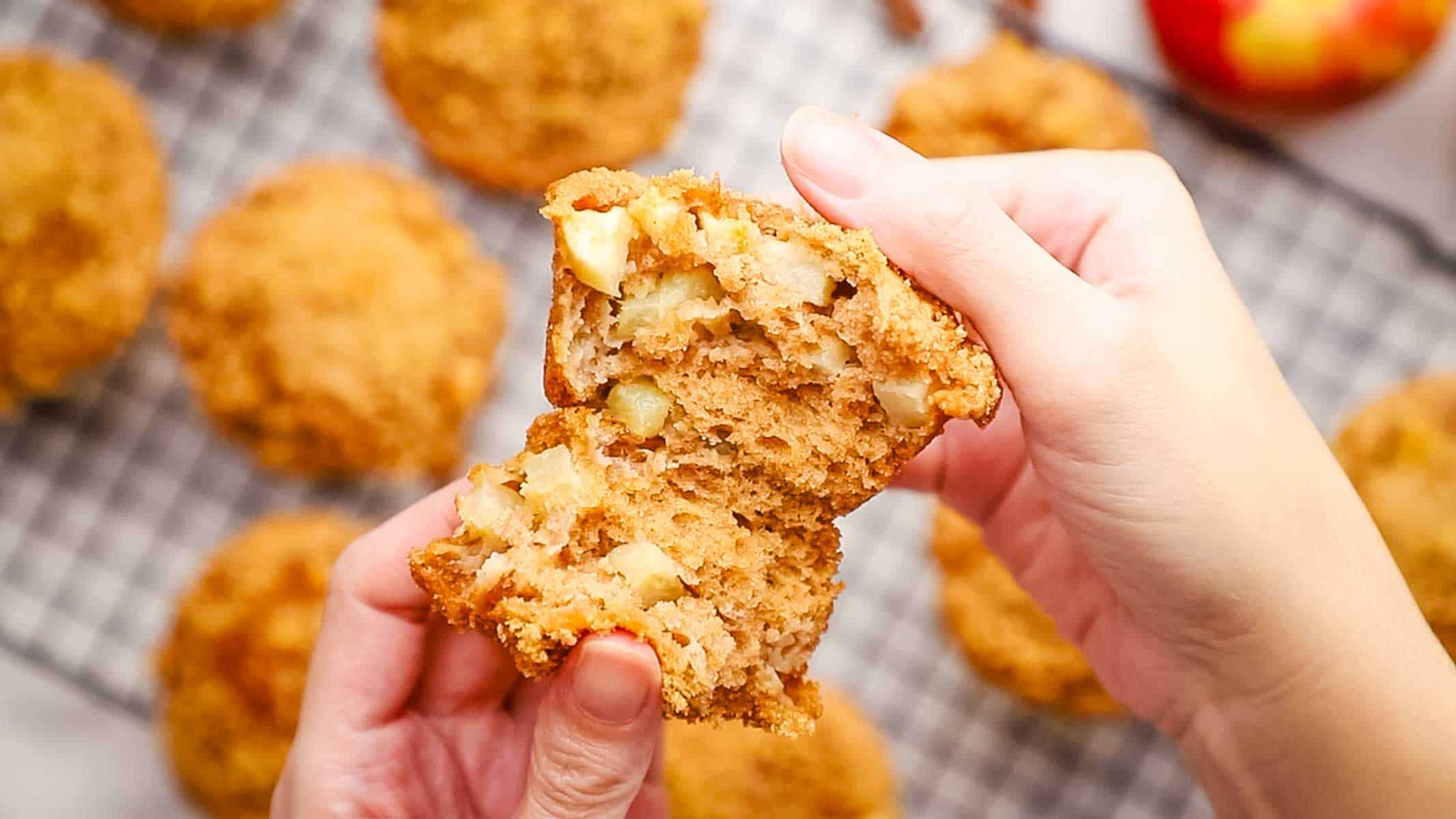 splitting an apple sour cream muffin in half to show the inside