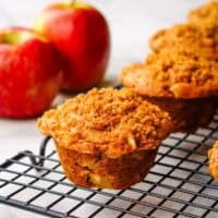 apple sour cream muffins cooling on a wire rack