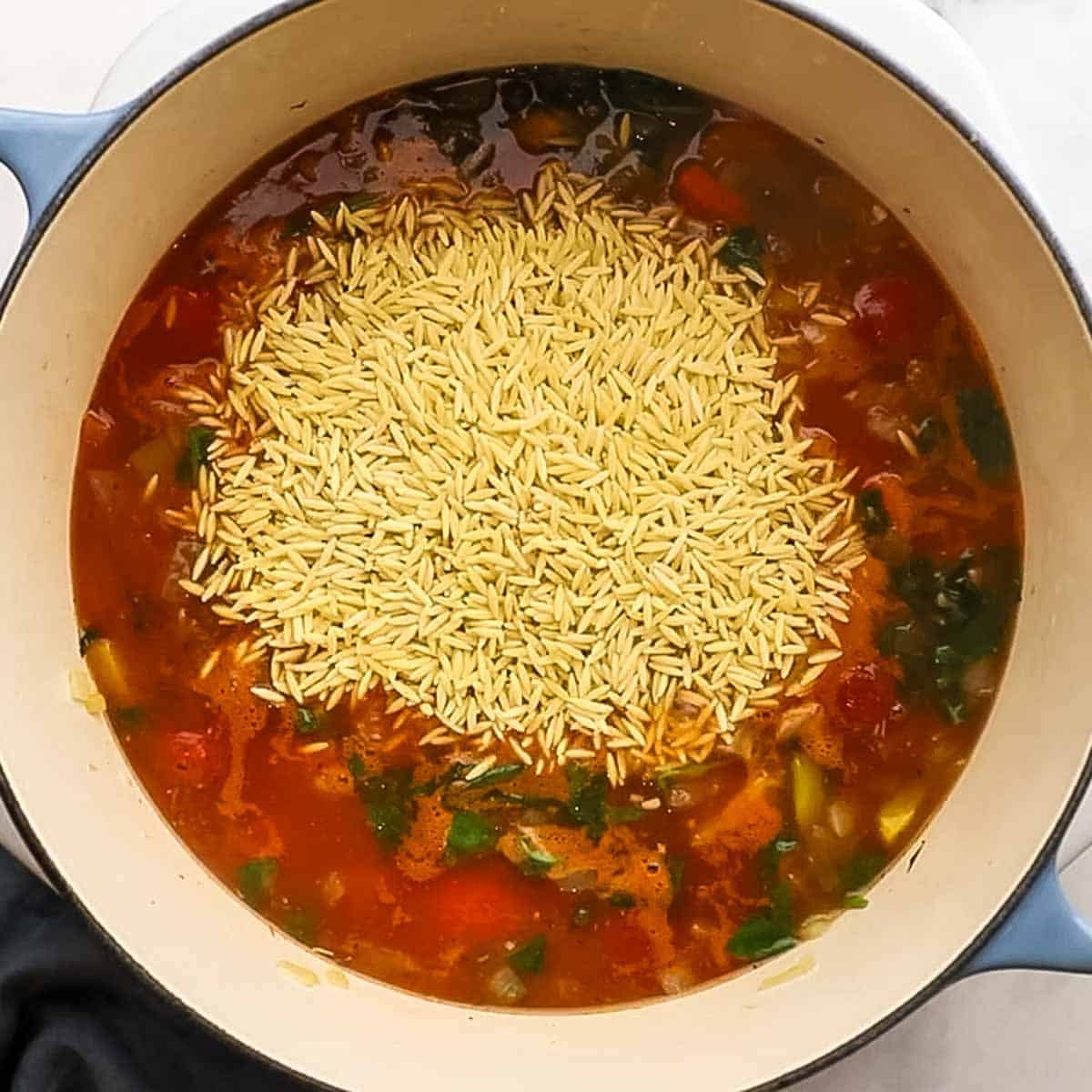 Orzo added to the stock and veggie mixture for baked chicken orzo.