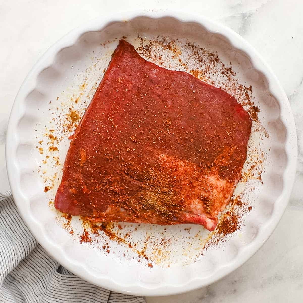 a steak with seasonings on it