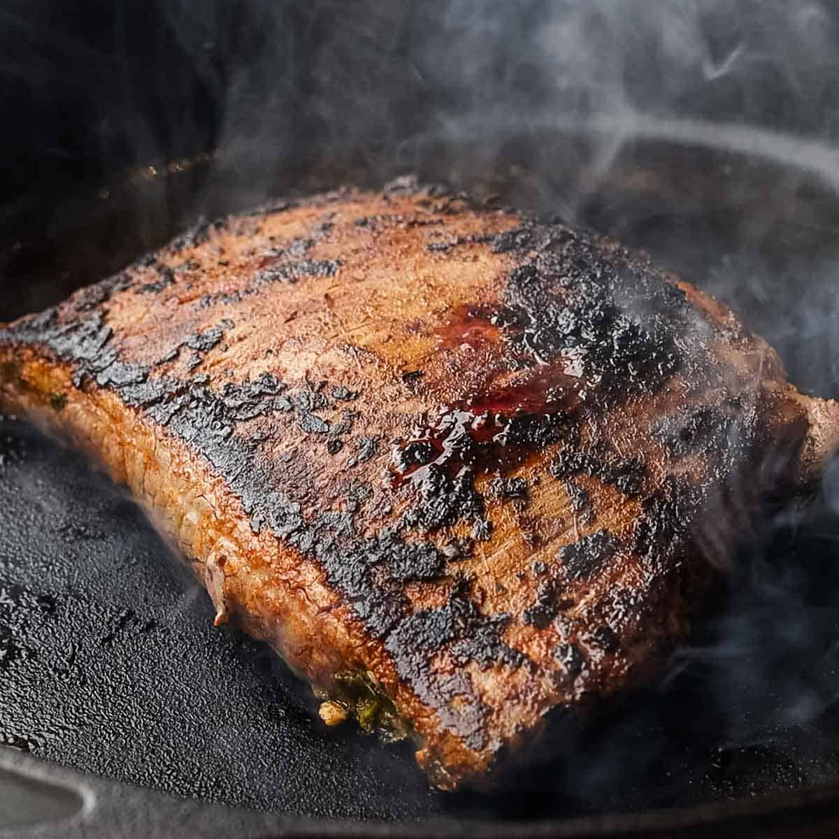 cooking steak on a caat iron skillet
