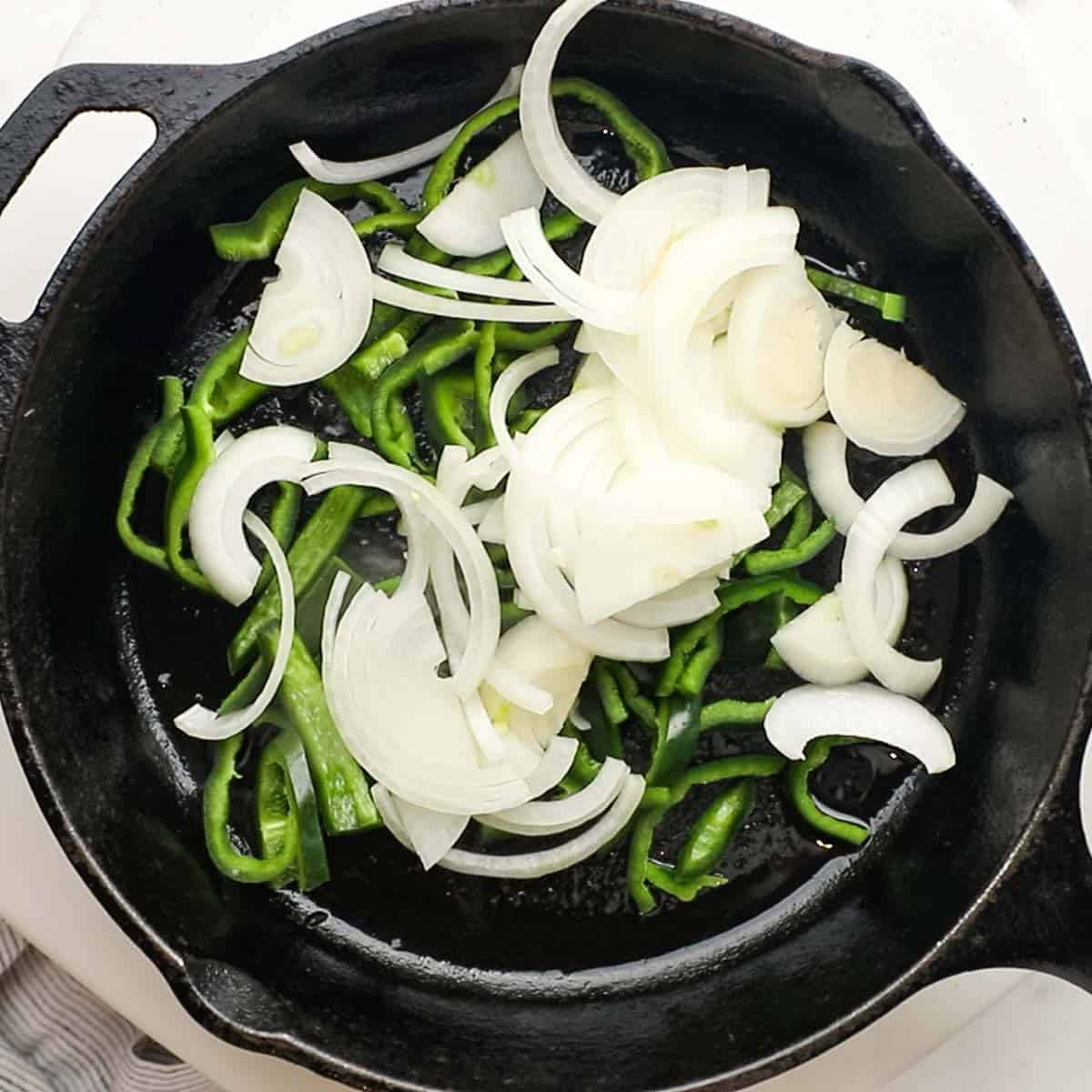 onions and poblano peppers added to the pan with some oil