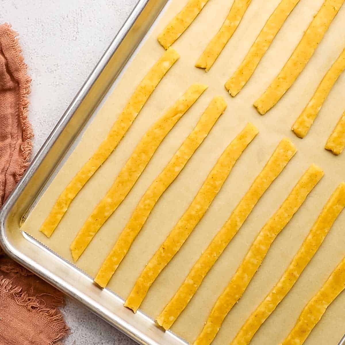 cheese straws placed on baking sheet