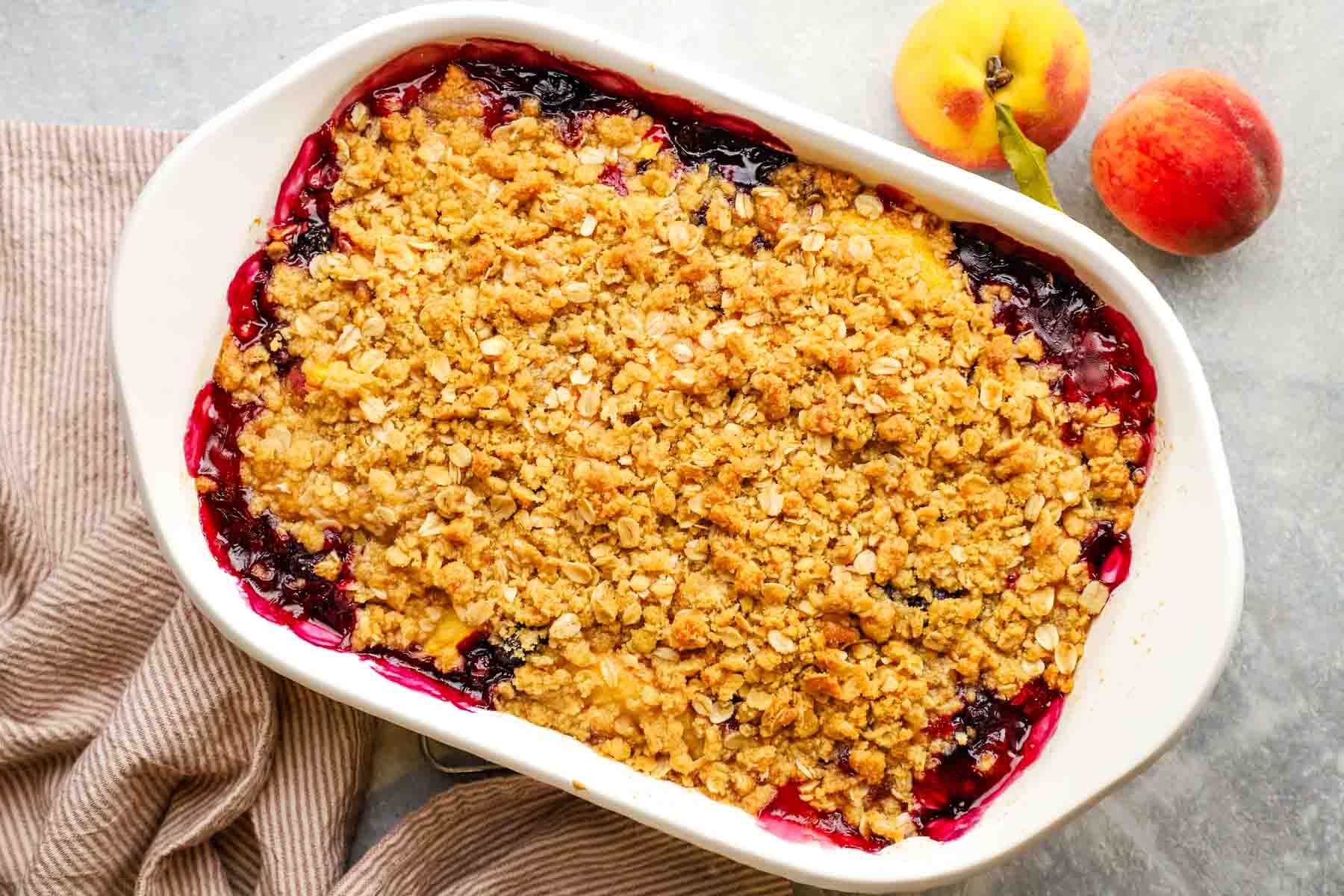 overhead view of peach blueberry crisp baked in a dish.