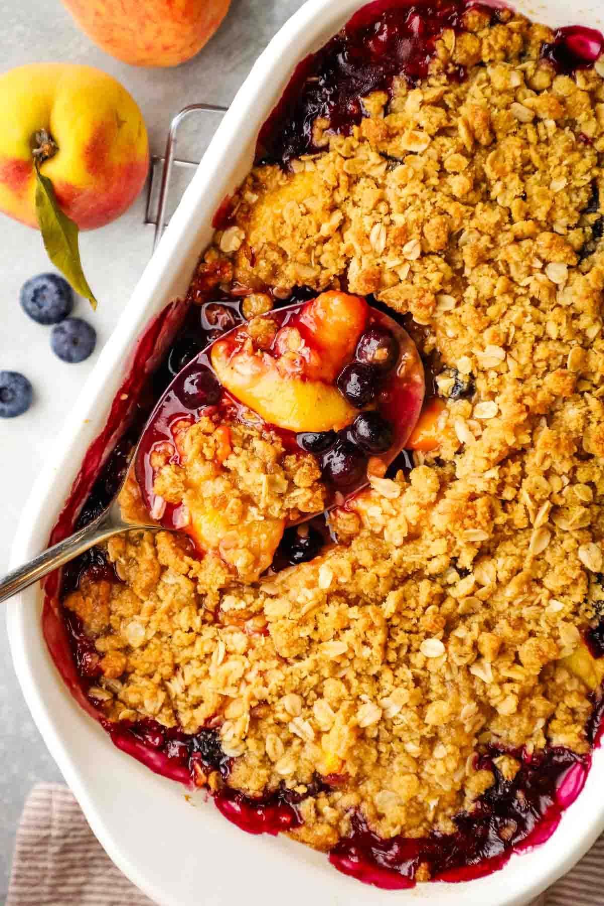 overhead view of peach blueberry crisp baked in a dish.