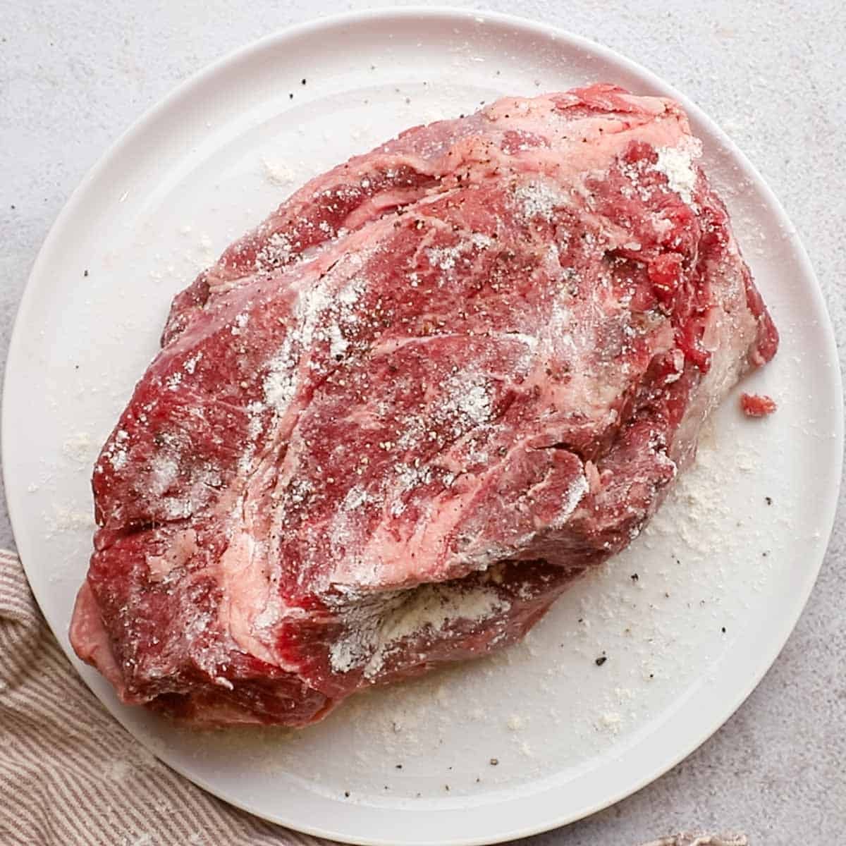 chuck roast seasoned with salt, pepper, and flour