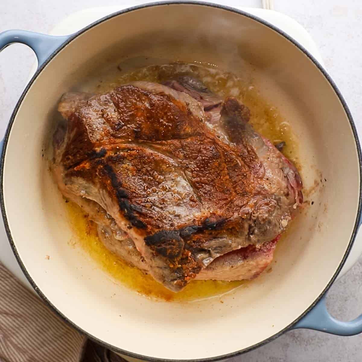 chuck roast searing in a dutch oven