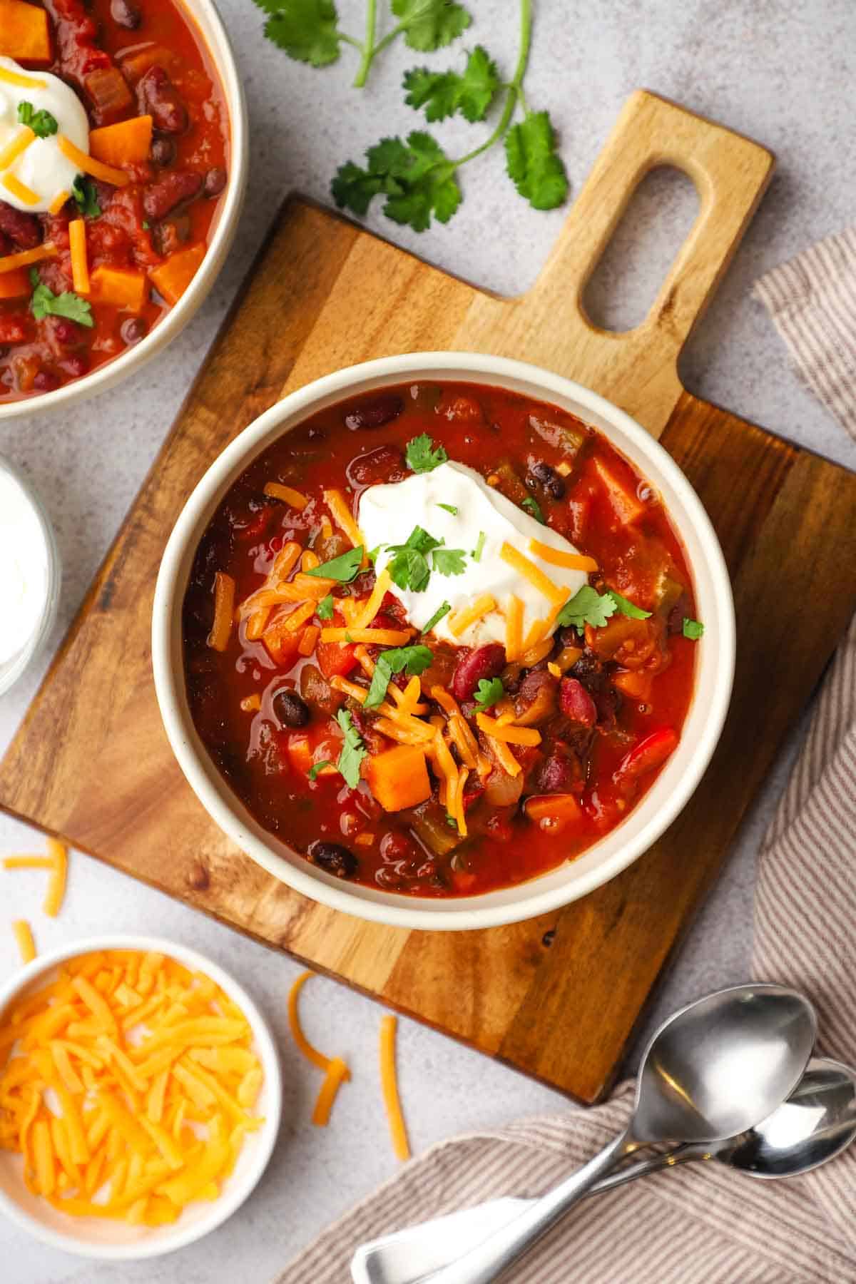 overhead view of a bowl of sweet potato chili with different toppings