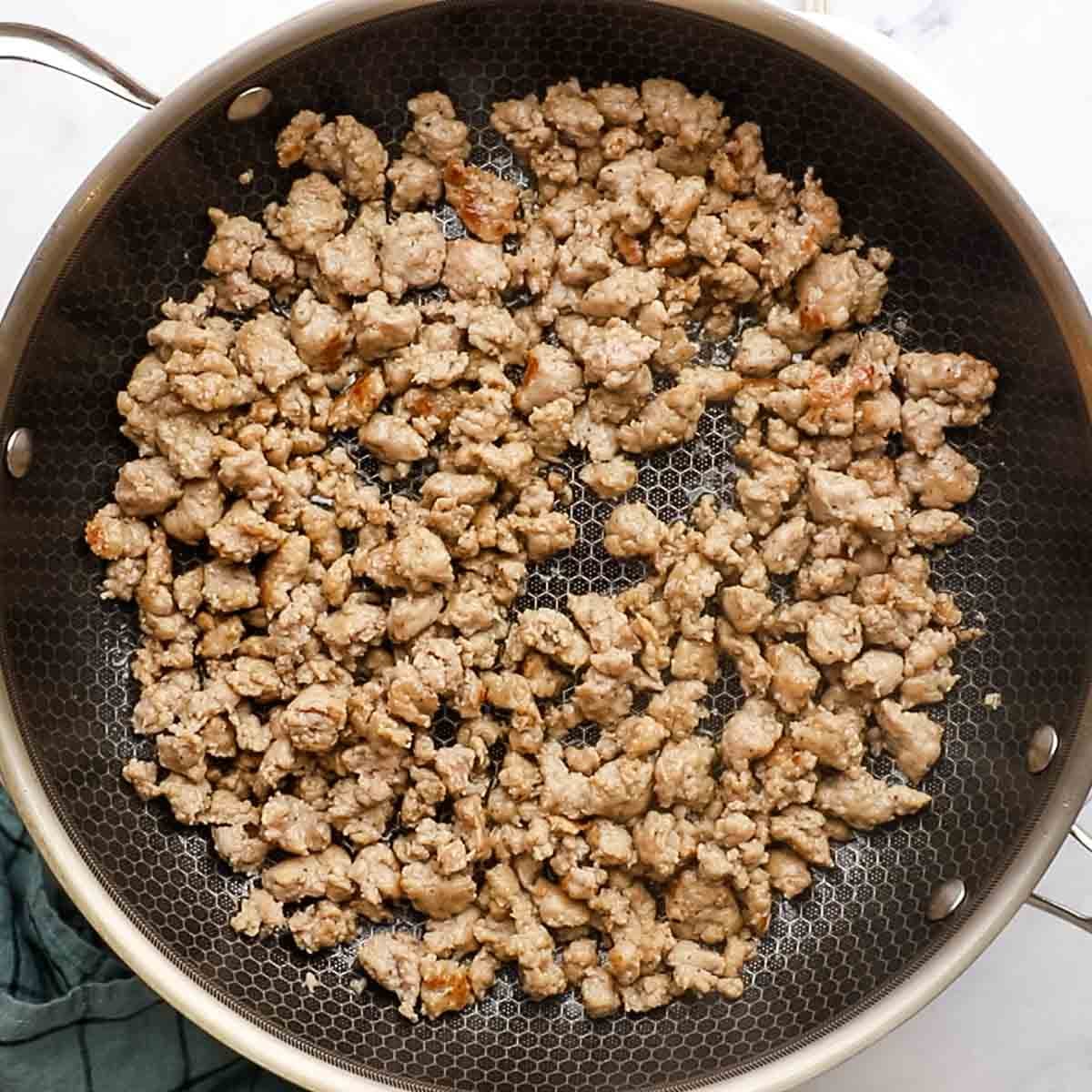 sausage cooking in a skillet