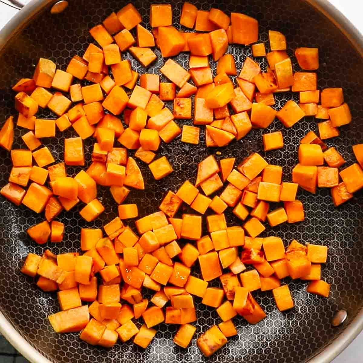 diced sweet potato cooking a skillet