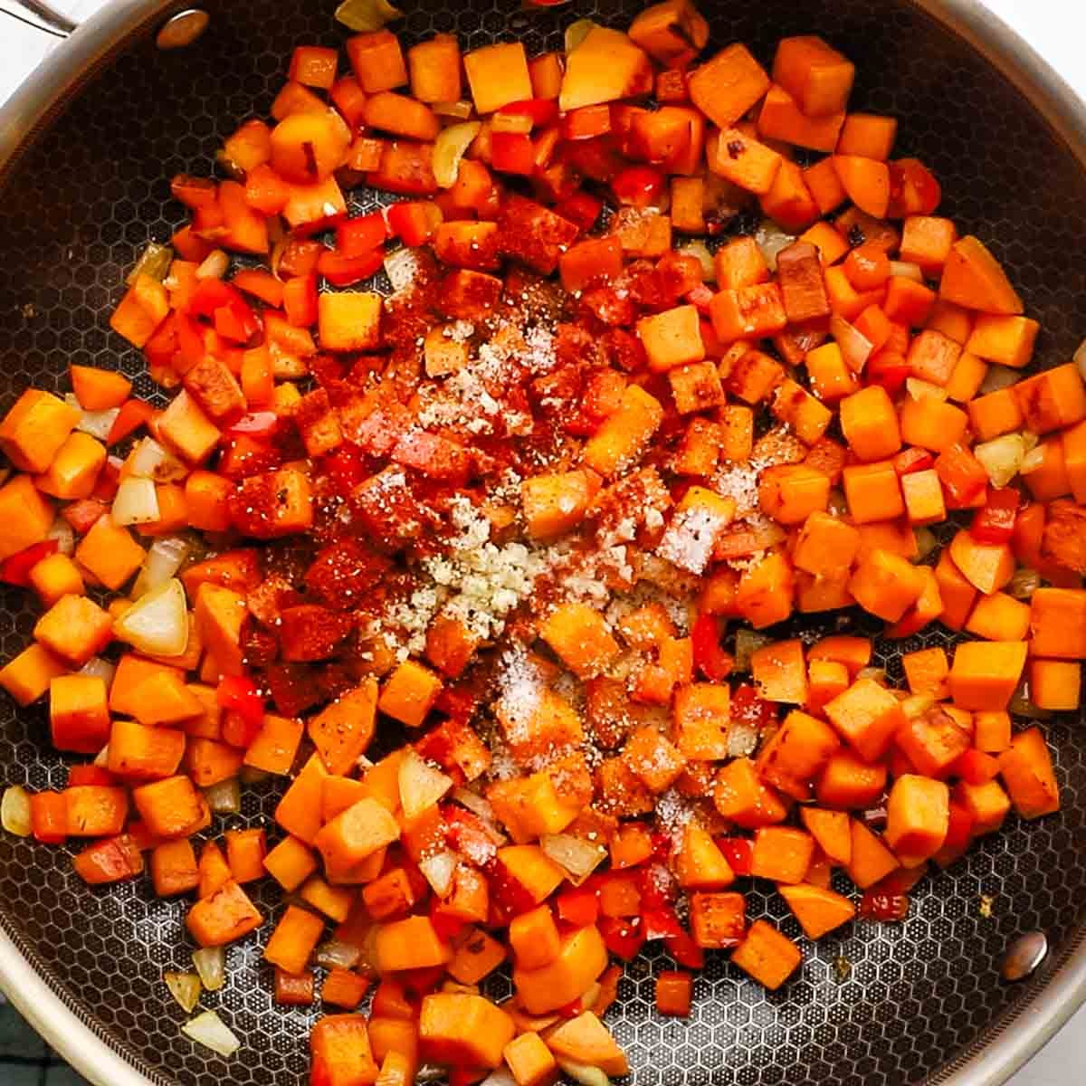 spices and seasonings added to the veggies in the skillet