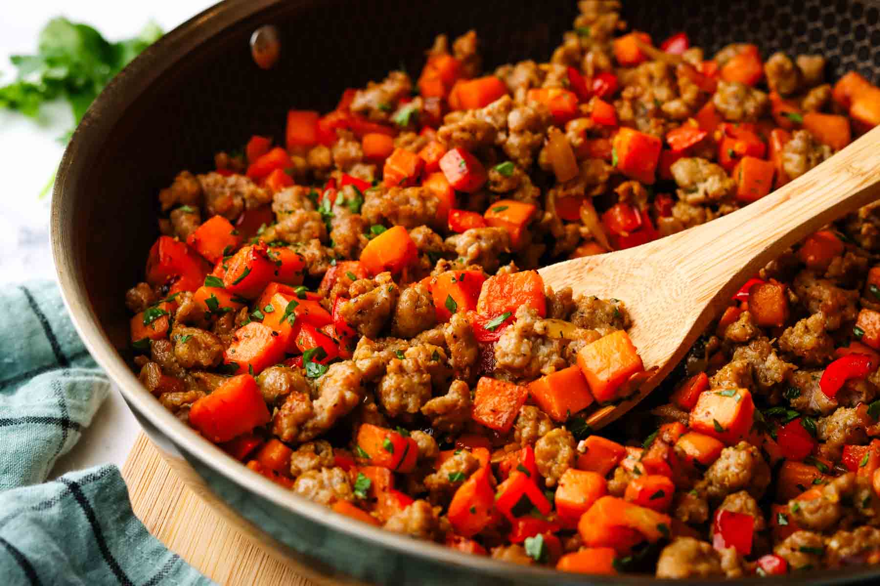 a skillet of sweet potato and sausage hash